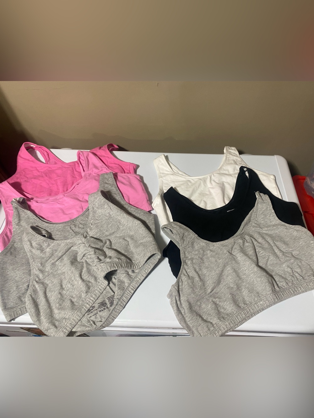 7 multicoloured Pull on sport bras size 40 one pink is a 38